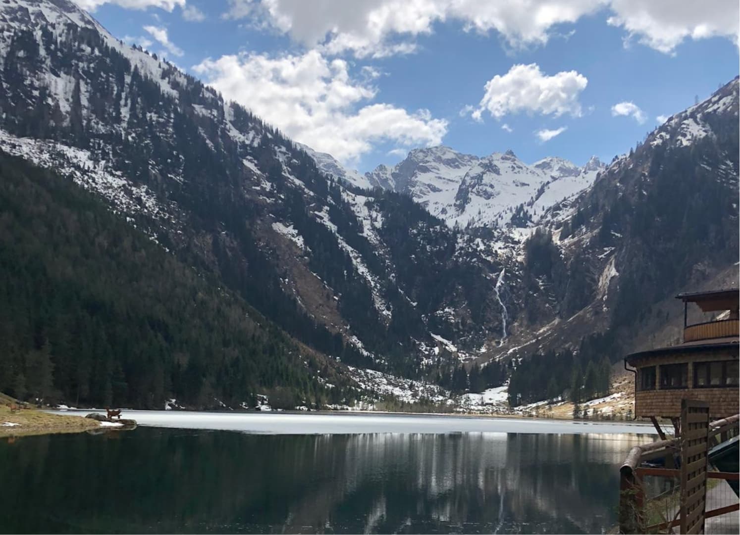 Bergsee mit Spiegelung und Eis